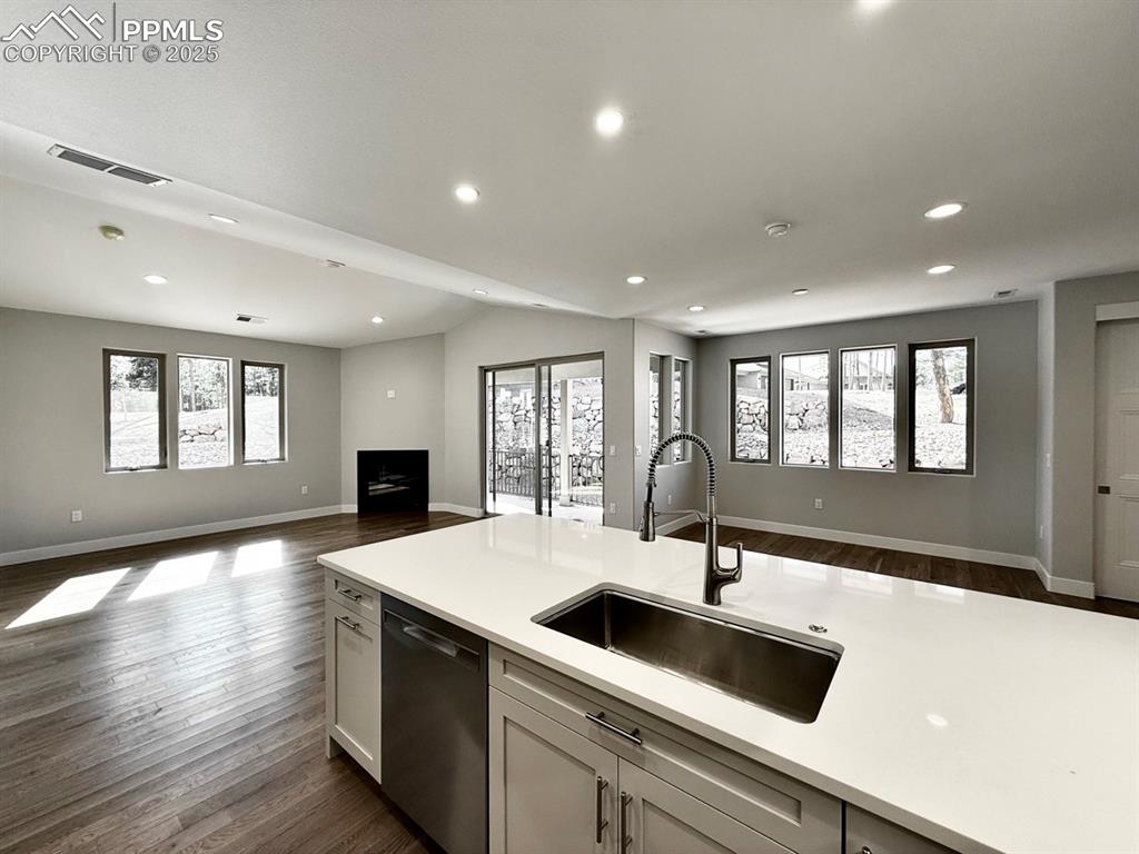 Image 14 of 28: Kitchen with open floor plan, recessed lighting, dark wood finished floors,