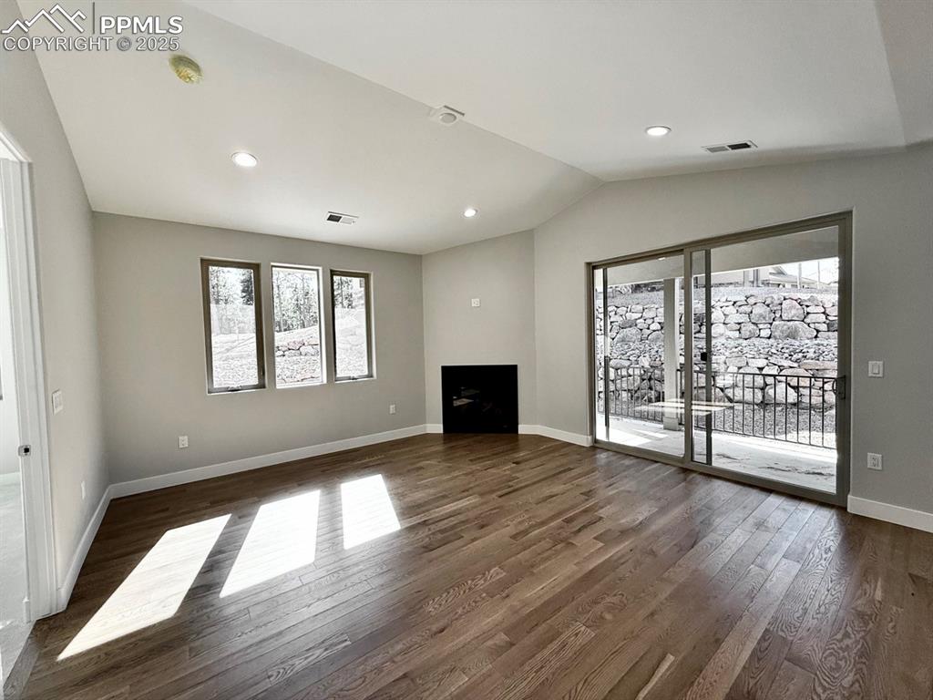 Image 15 of 28: Unfurnished living room with healthy amount of natural light, recessed ligh