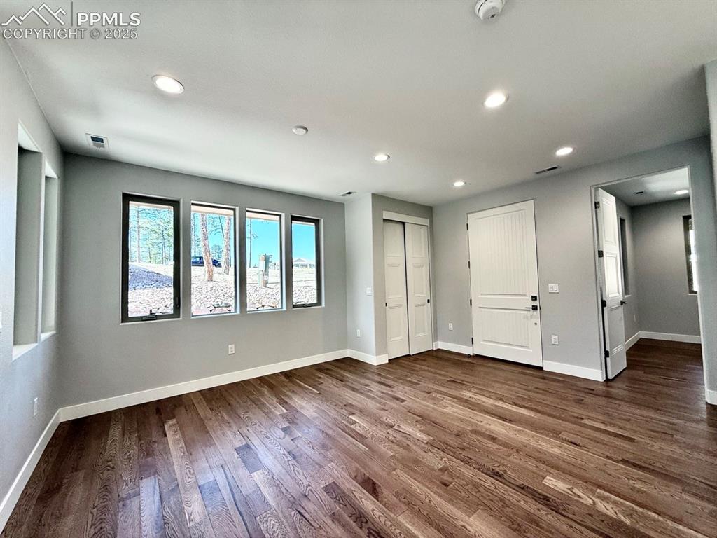 Image 7 of 29: Dining Room with Wood Flooring and Large Windows.