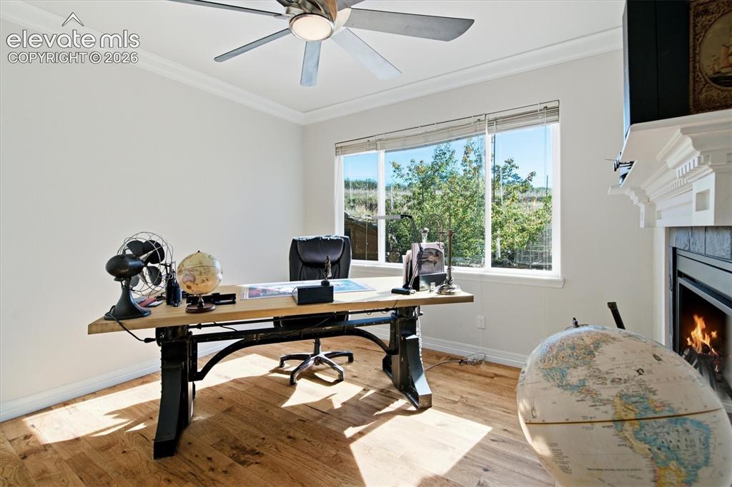 Image 42 of 48: Main floor office or family room w see through fireplace