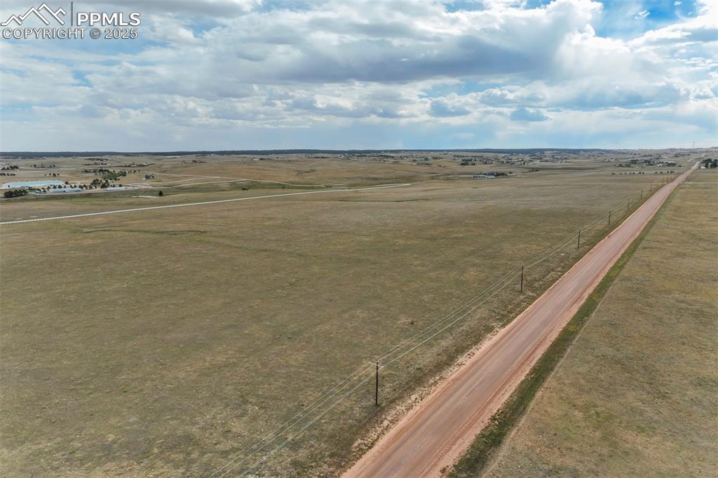 Image 13 of 19: Birds eye view of property with a rural view