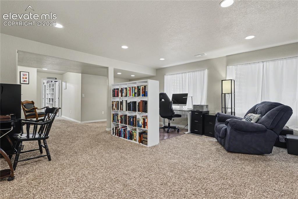 Image 30 of 38: Carpeted interior space featuring recessed lighting and multiple windows wi