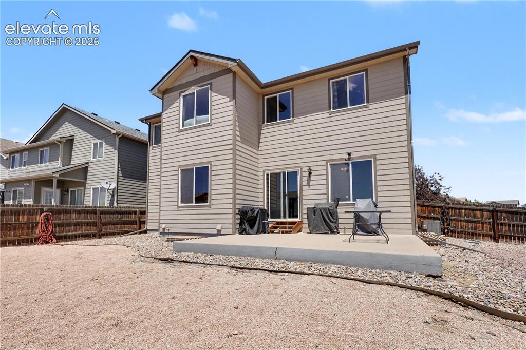 Image 38 of 38: Multi-level siding exterior featuring a ground-level concrete patio