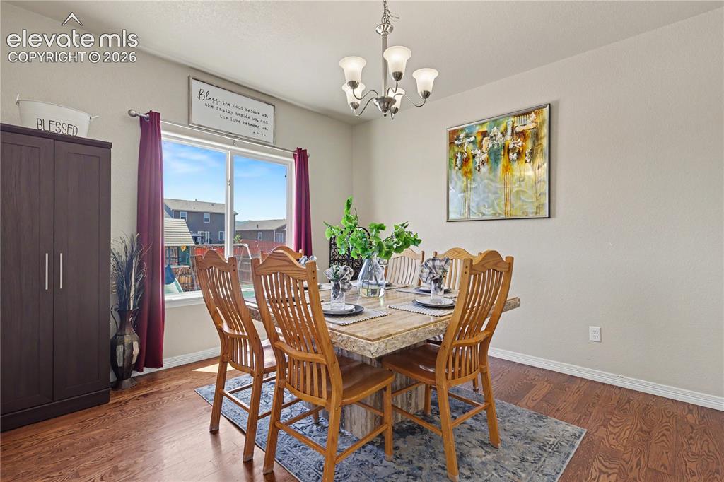 Image 8 of 38: Dining space featuring wood-finish flooring, a large window, and a built-in