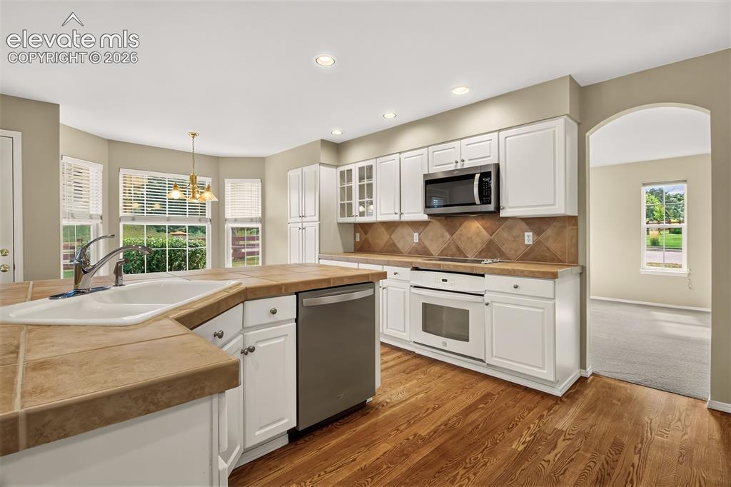 Image 16 of 42: Hardwood Flooring, Tile Backsplash