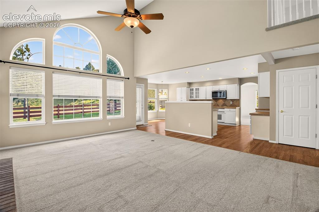 Image 9 of 42: Family Room Looking Into The Kitchen, Ceiling Fan and Central A/C