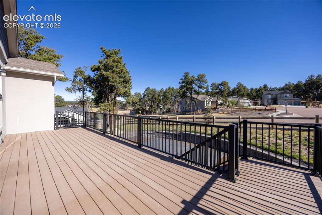 Image 17 of 48: Spacious outdoor deck with composite decking and black metal railings
