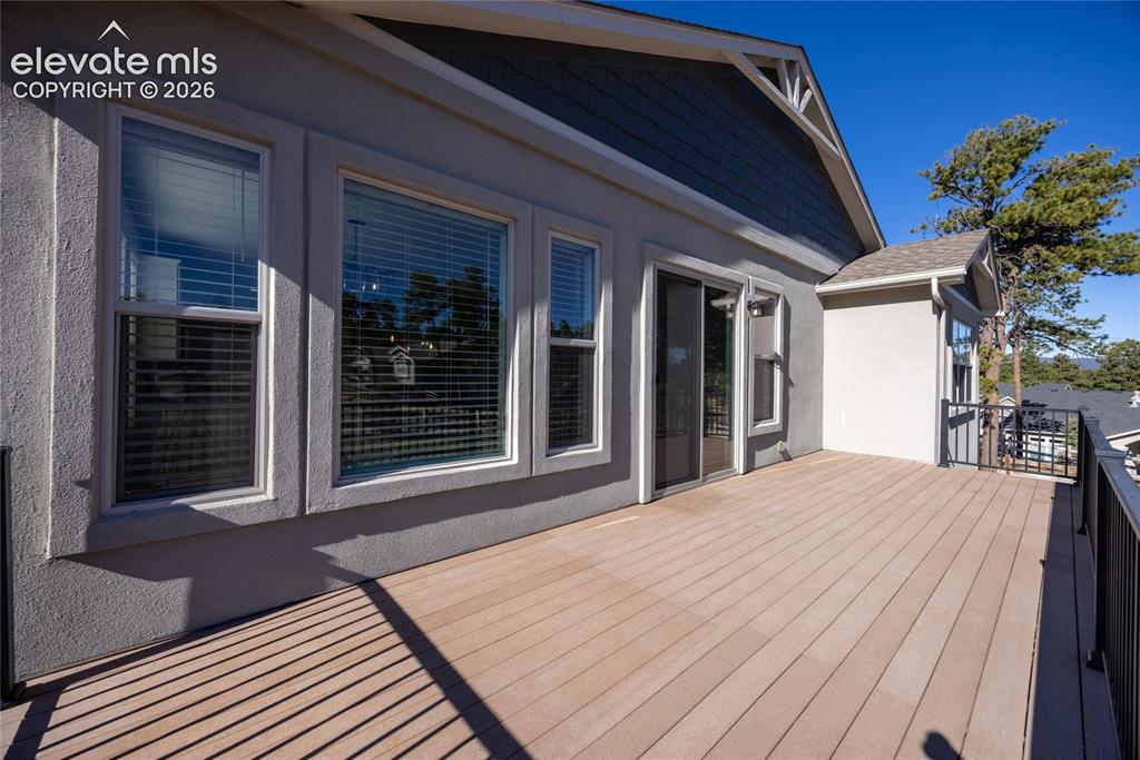 Image 18 of 48: Expansive deck featuring composite decking and black metal railings