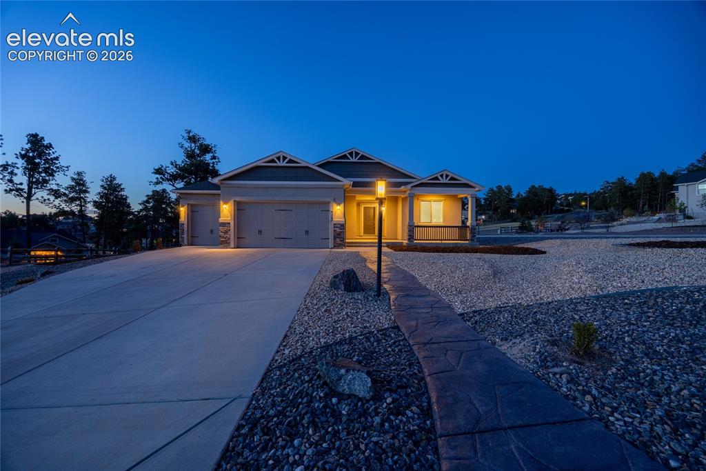 Image 2 of 48: Single-story residence featuring a covered front porch, attached garages wi