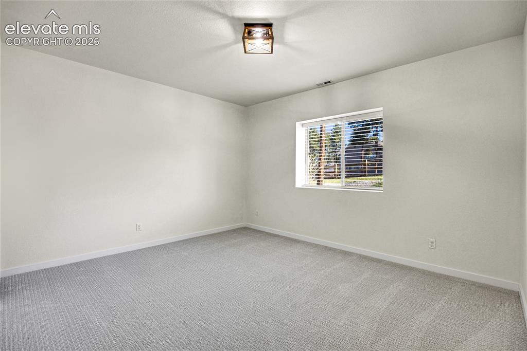 Image 32 of 48: Recessed window with blinds, overhead flush-mount lighting fixture, light-c