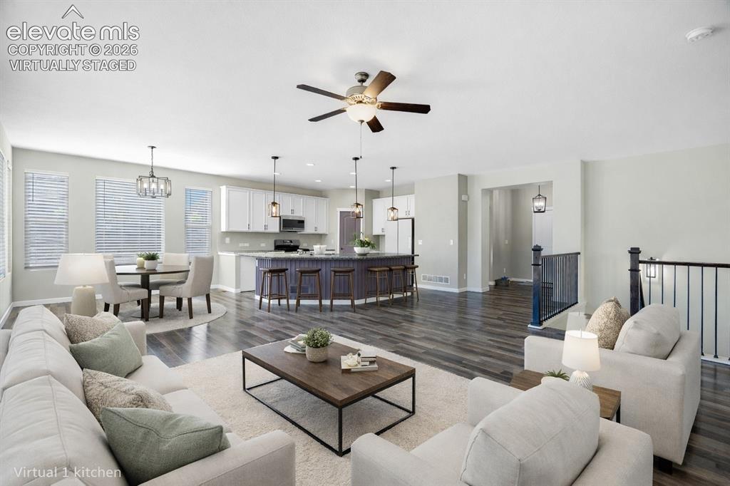 Image 6 of 48: virtually staged Spacious open-concept layout featuring wood-finish floorin