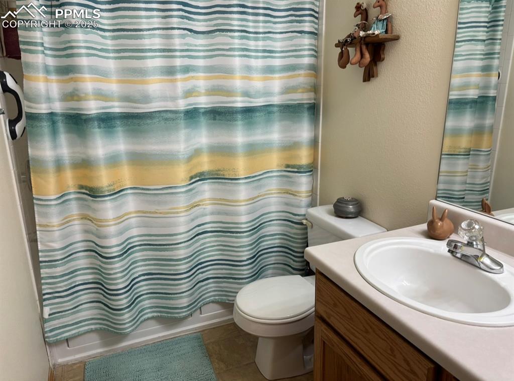 Image 10 of 15: Bathroom with vanity, shower / bath combination with curtain, a textured wa