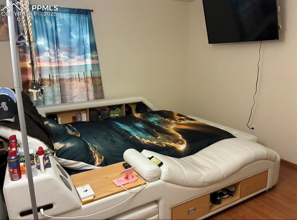 Image 11 of 15: Bedroom featuring wood finished floors