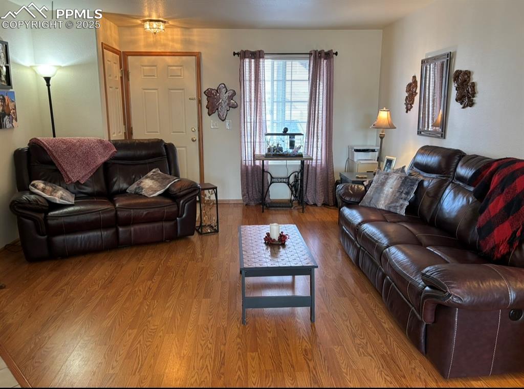 Image 2 of 15: Living room with wood finished floors