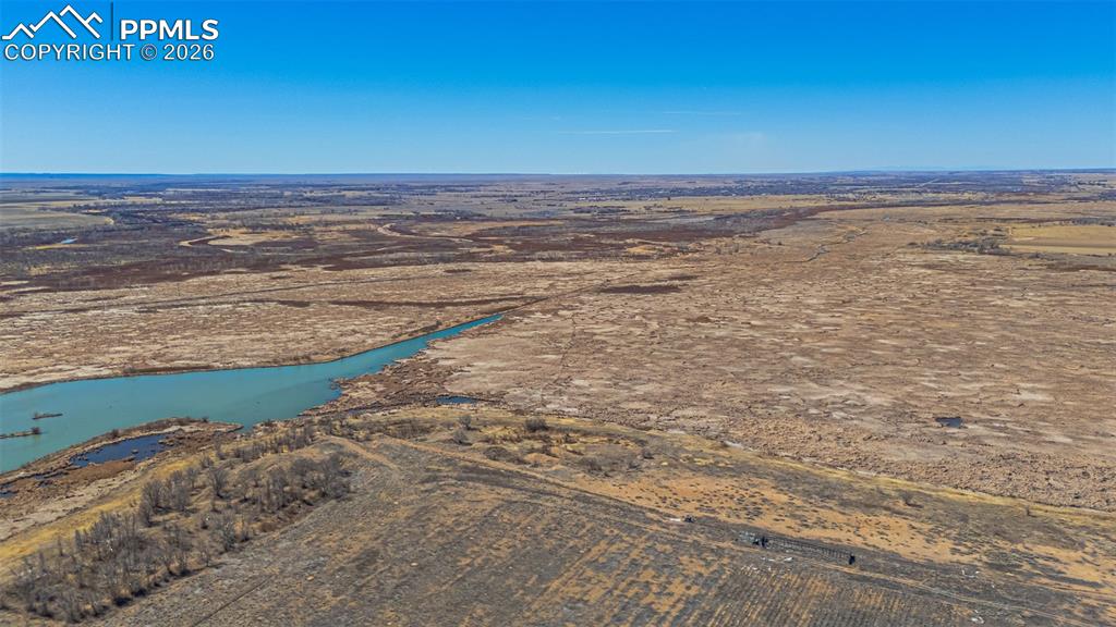 Image 12 of 33: The property features a single-story residence with a light-colored roof, s