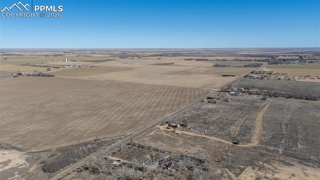 Image 28 of 33: The property features a single-story structure with a light grey exterior a