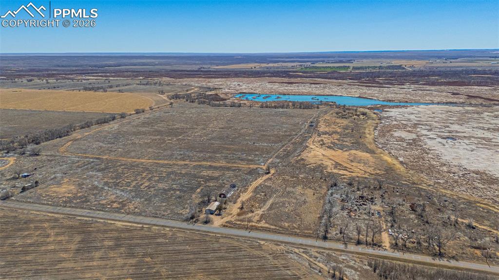 Image 30 of 33: Expansive rural landscape featuring vast agricultural fields under a clear