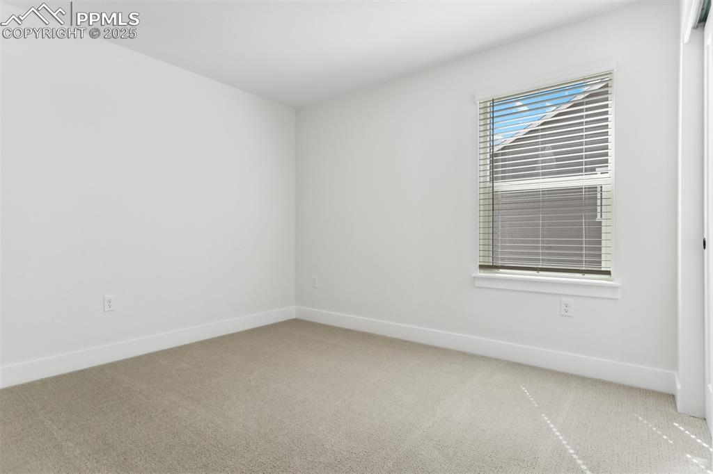 Image 11 of 20: Spare room with light carpet and baseboards