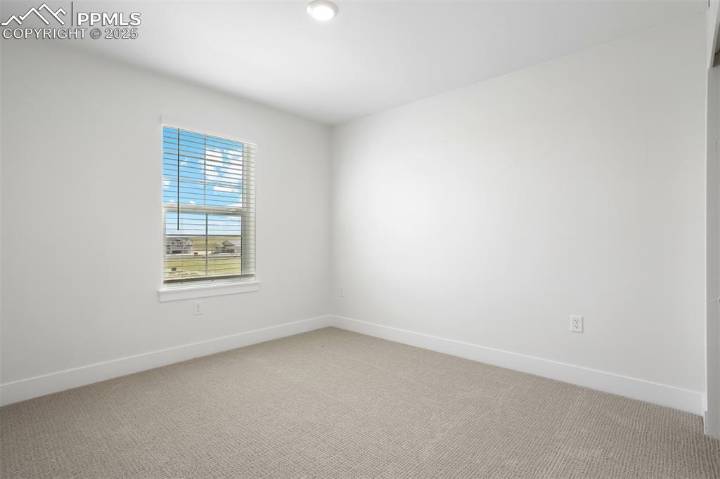Image 12 of 20: Unfurnished room featuring light carpet and baseboards