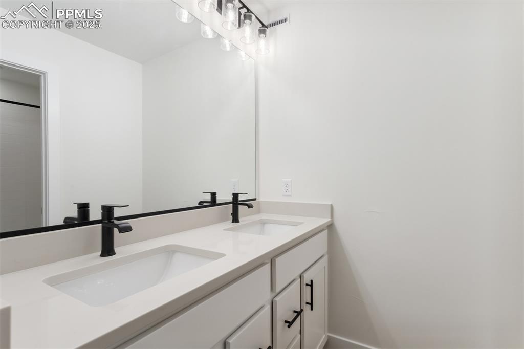 Image 13 of 20: Bathroom with double vanity and a sink