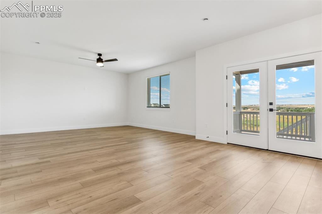 Image 2 of 20: Spare room with light wood-type flooring, baseboards, and ceiling fan