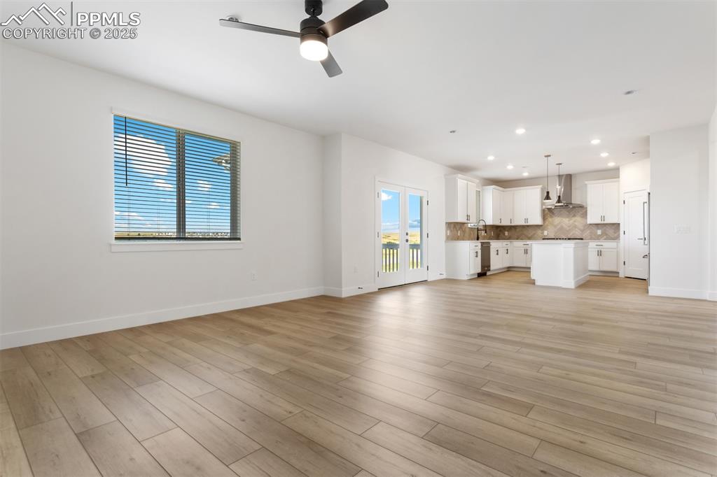 Image 3 of 20: Unfurnished living room featuring light wood finished floors, ceiling fan,