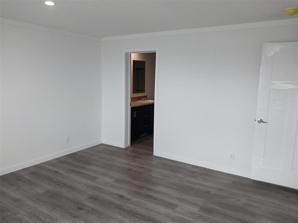Image 2 of 25: Spare room featuring ornamental molding, dark wood-style floors, recessed l