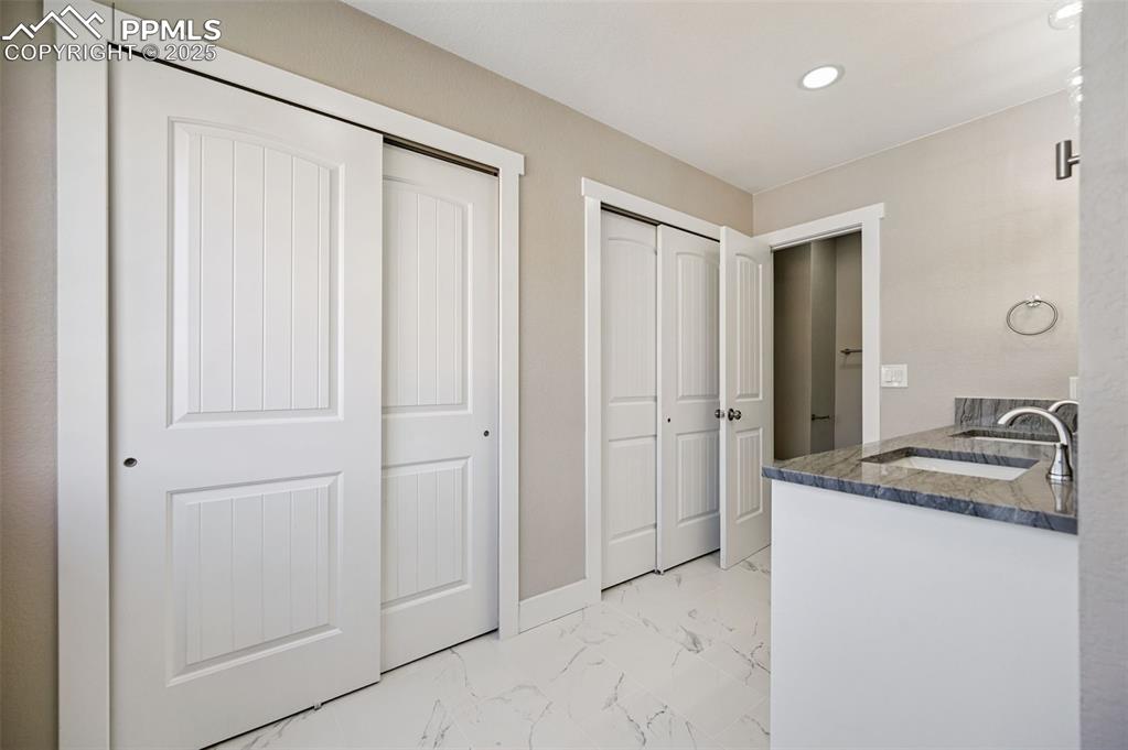 Image 14 of 45: Primary Bathroom, double vanity, two closets