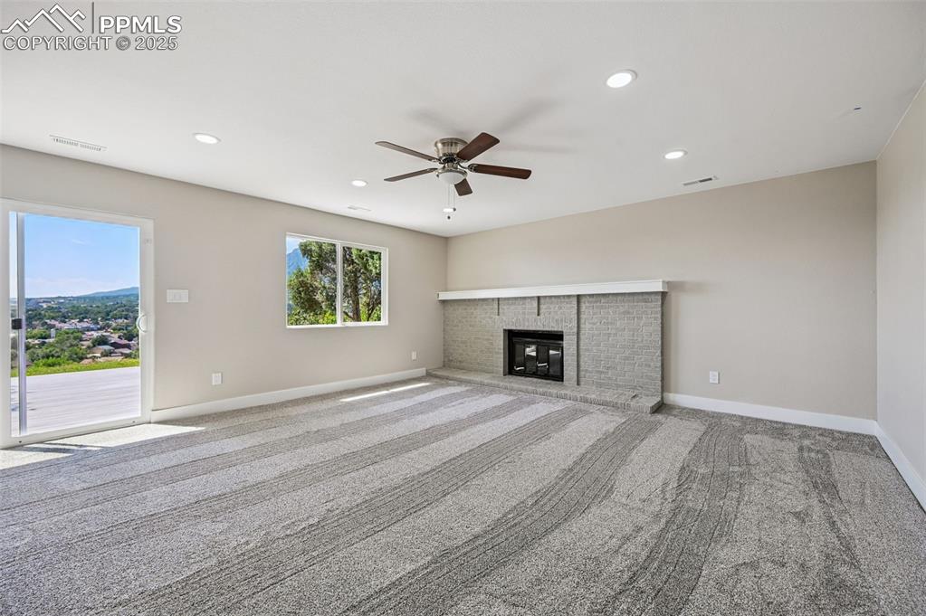 Image 24 of 45: Family Room, walk-out to deck, fireplace