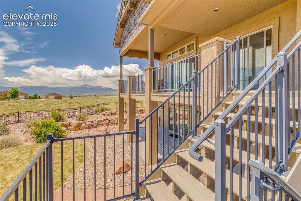 Image 20 of 48: Deck from great room walk out, stairs to fenced back yard area