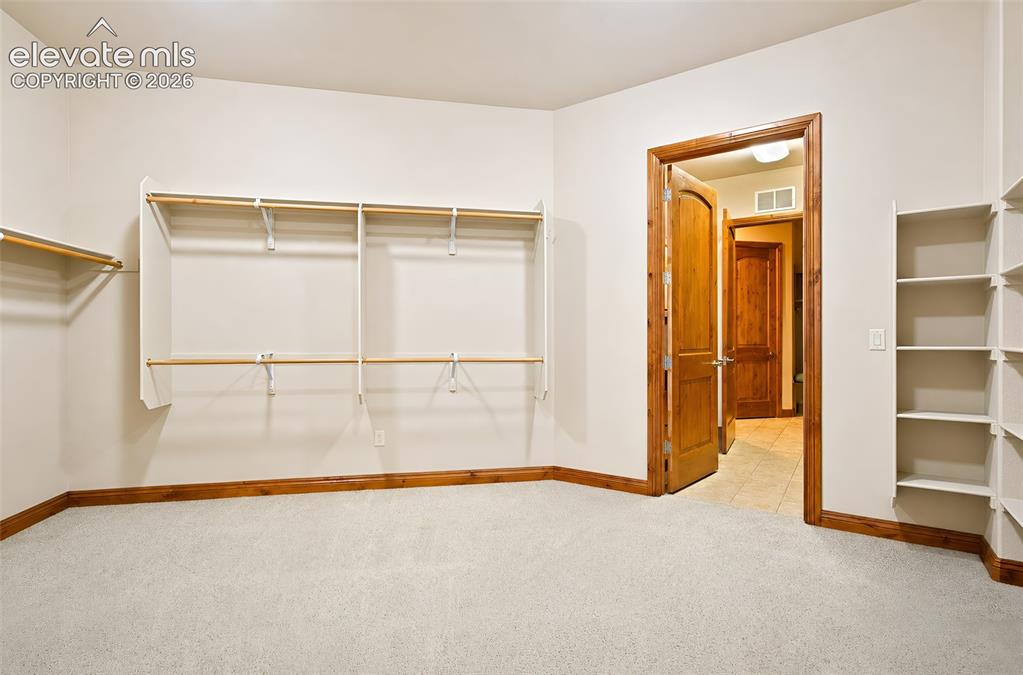Image 28 of 48: Primary bedroom walk in closet