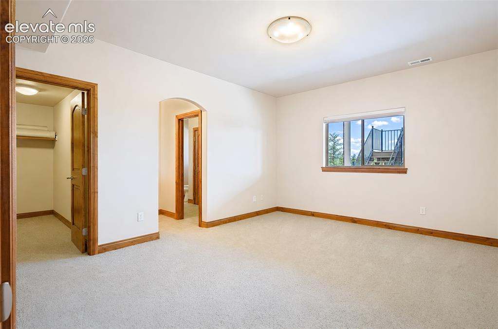 Image 36 of 48: Basement bedroom #1 with walk in closet - Jack and Jill bathroom