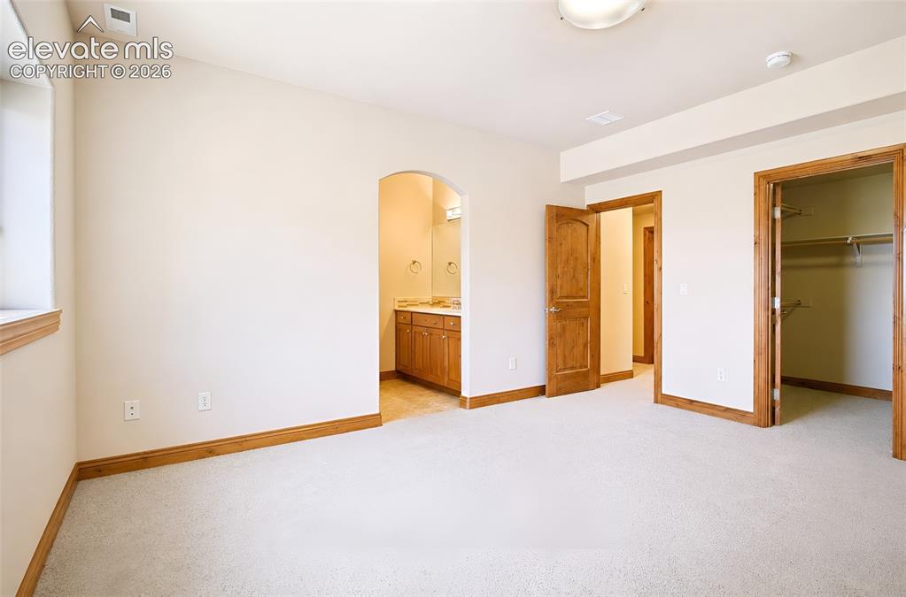Image 40 of 48: Basement bedroom #2 with walk in closet - Jack and Jill bathroom