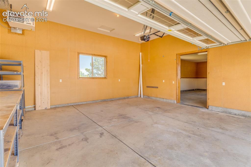 Image 46 of 48: Detached 2 car heated garage with shop to the right.