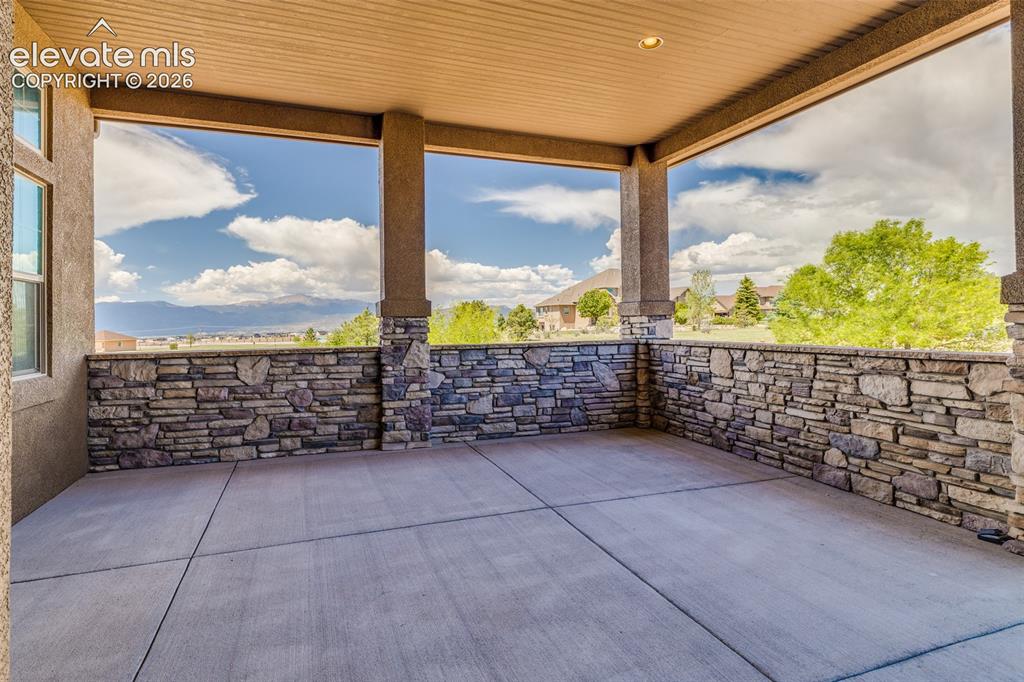 Image 5 of 48: Front covered porch with Pikes Peak veiw