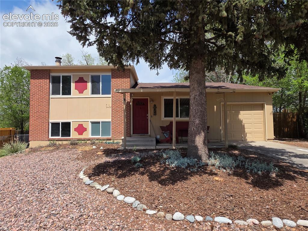 Caption: Brick and siding exterior with decorative accents, an attached single-car garage, a covered front en