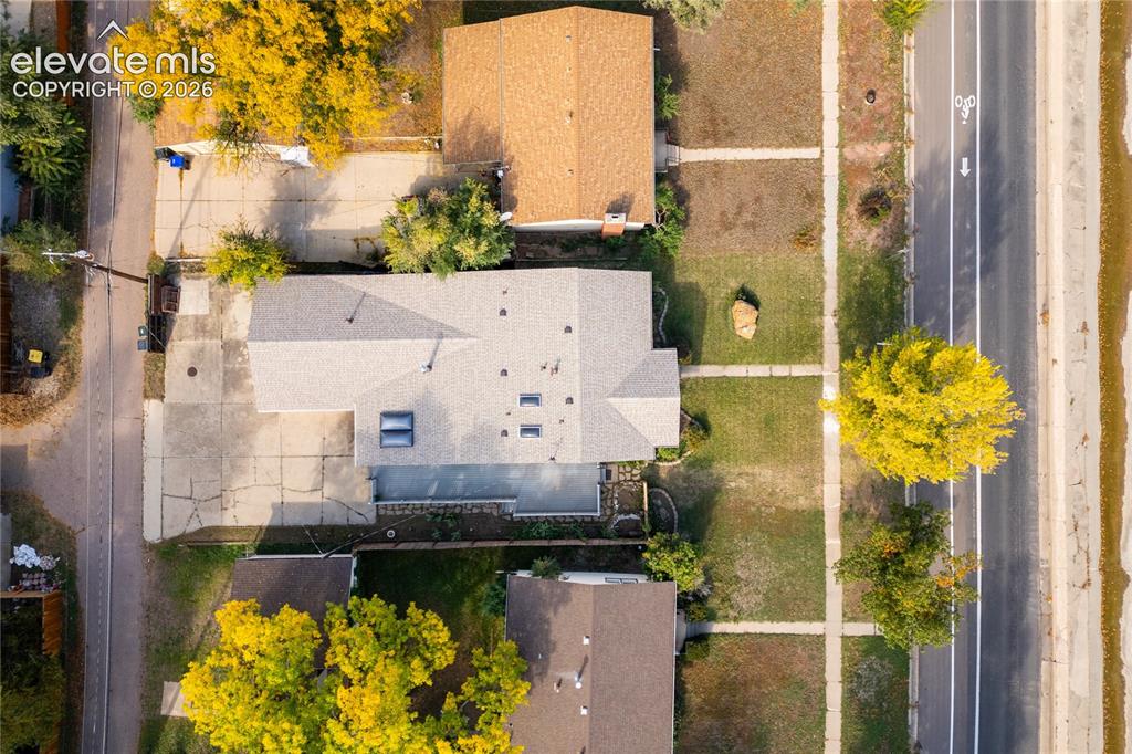 Image 26 of 29: Single-story residence with a light gray shingle roof, multiple skylights, 