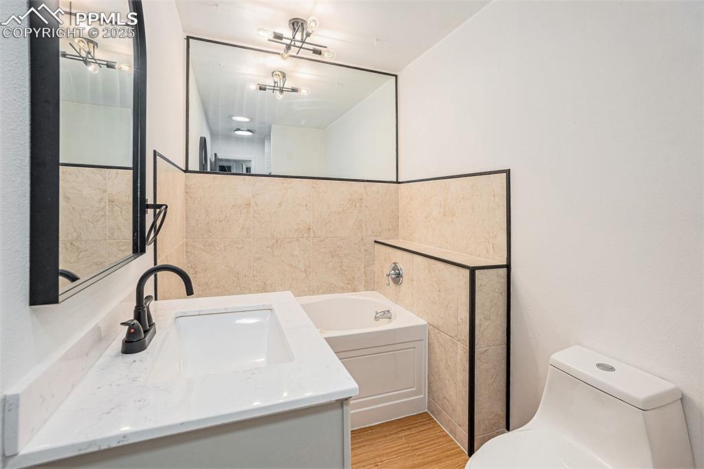 Image 31 of 35: Full bath with vanity, wood finished floors