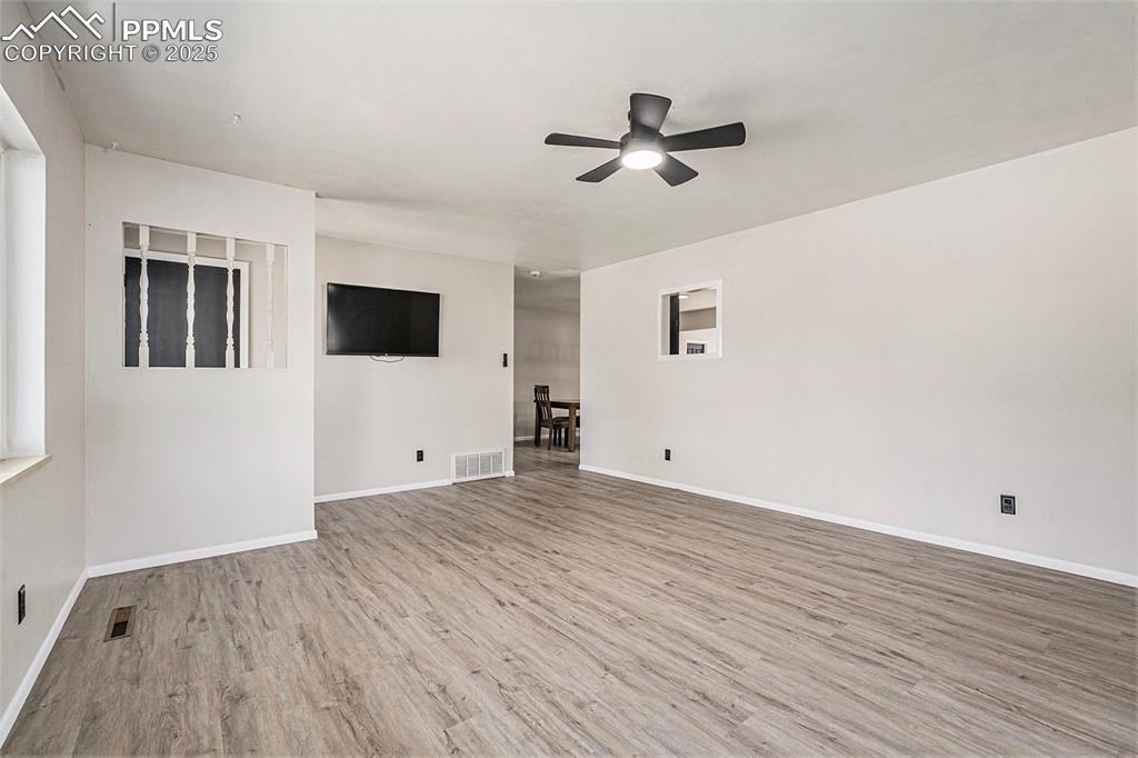 Image 8 of 35: Living room with ceiling fan and (LVP) flooring