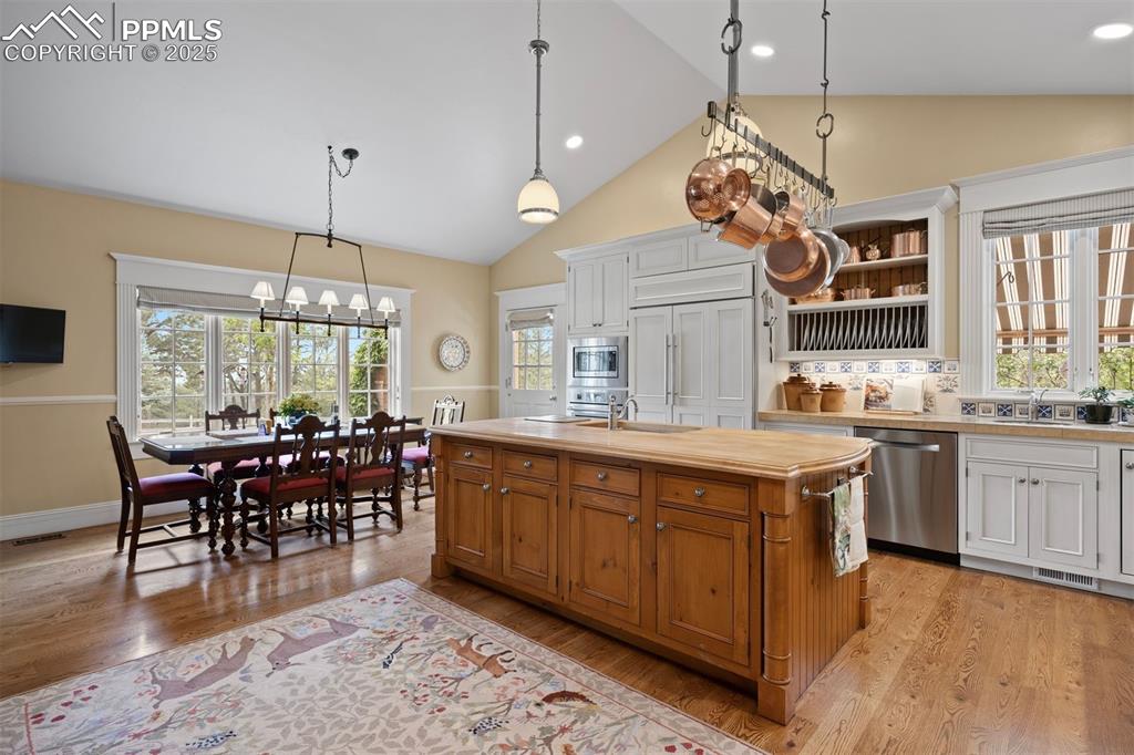 Image 13 of 49: A charming eat-in area with large window overlooks the West yard and access