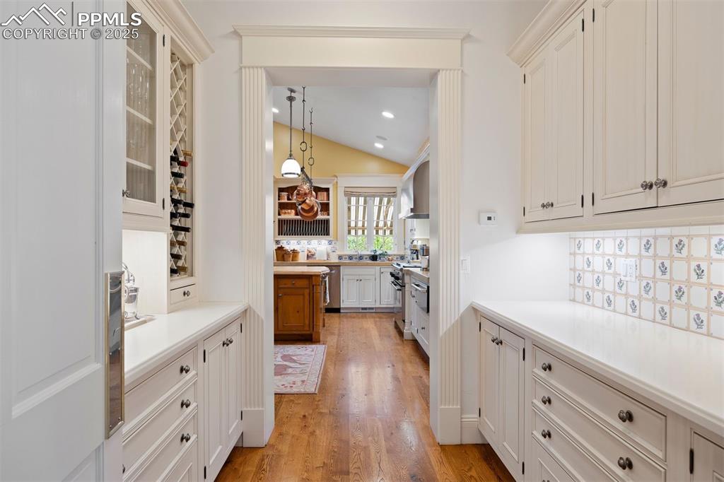 Image 14 of 49: Butler’s pantry connects the kitchen and dining room, featuring hand-painte
