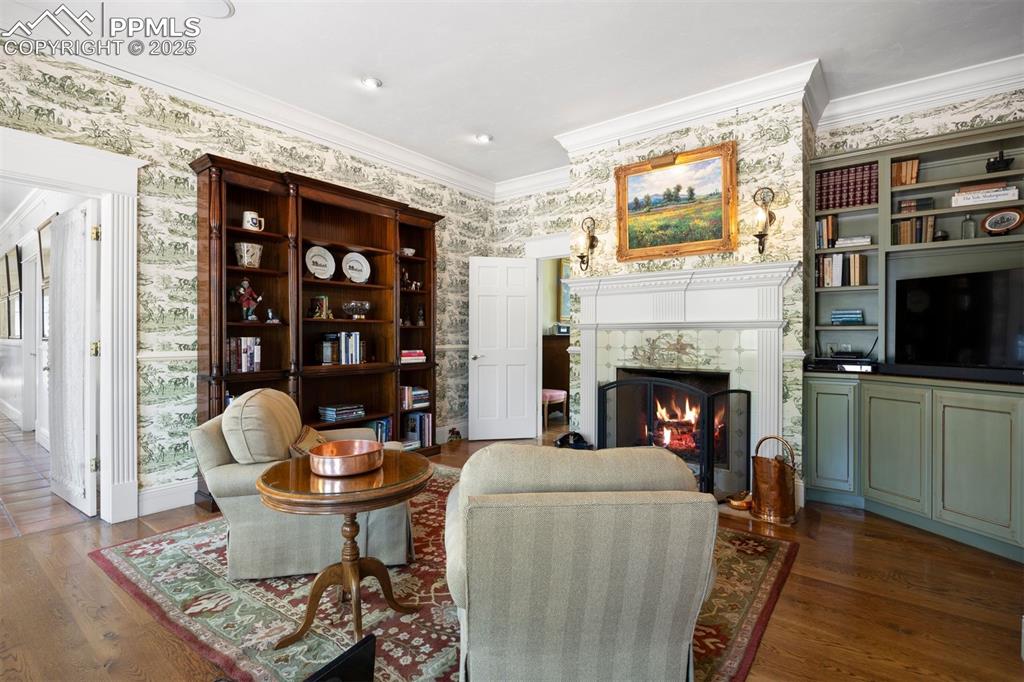 Image 17 of 49: A showpiece fireplace in the study, with hand-painted fox hunt tile and a 1
