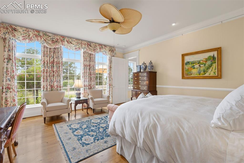 Image 18 of 49: Main-floor primary bedroom with floor-to-ceiling windows overlooking the We