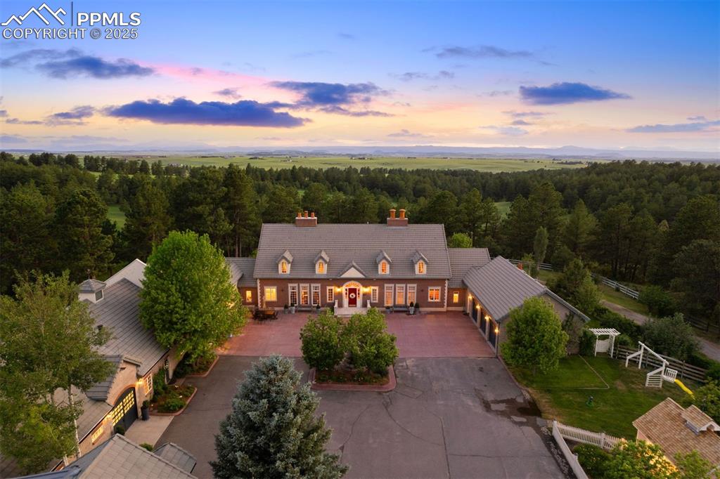 Image 2 of 49: The stately red brick residence anchors the adjacent masonry carriage house