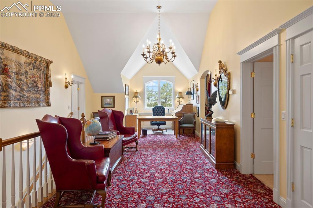 Image 23 of 49: Upstairs central hall, a spacious space currently used for an office, game 