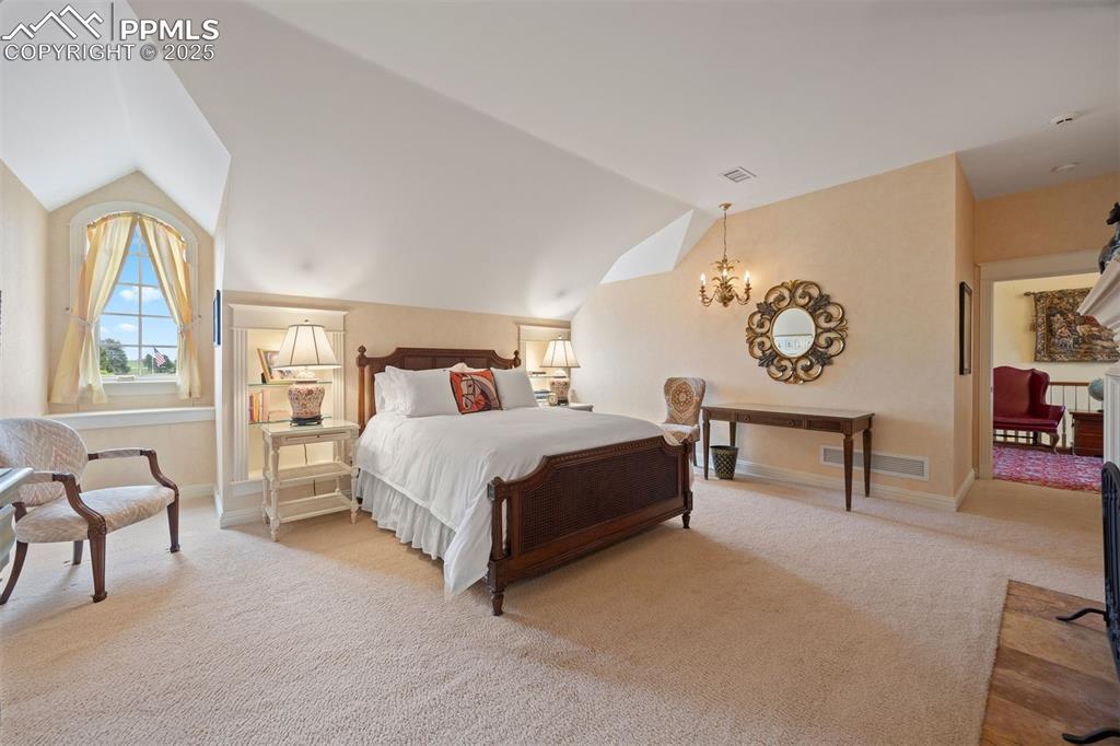 Image 24 of 49: Upstairs bedroom one, with brick fireplace, two dormer windows, a spacious 
