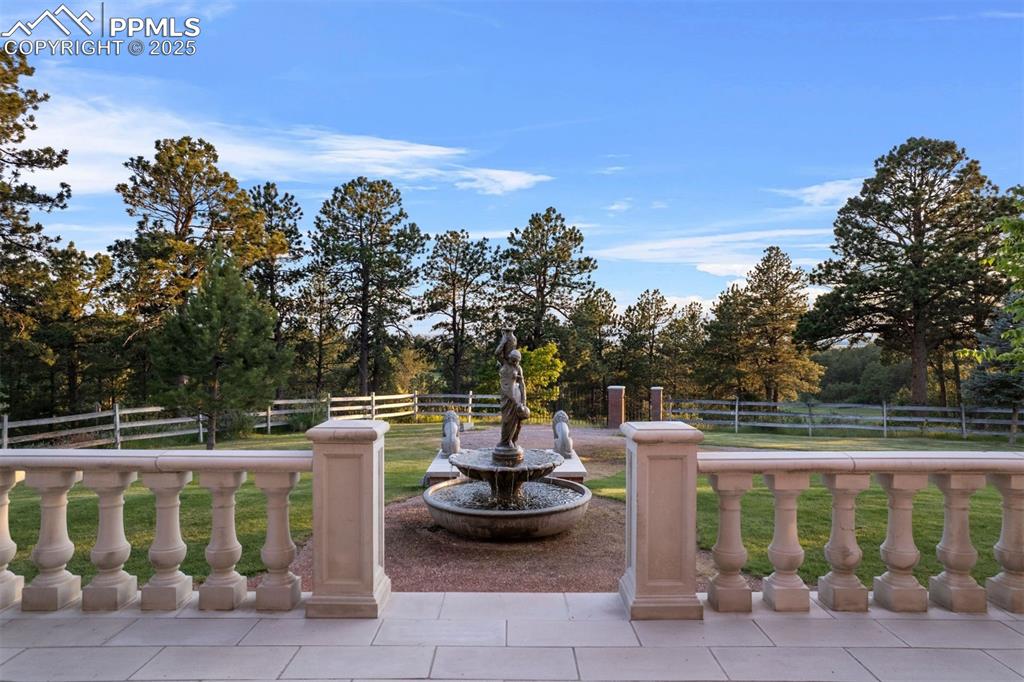 Image 26 of 49: The west cast stone terrace offers a tranquil vantage point with balustrade