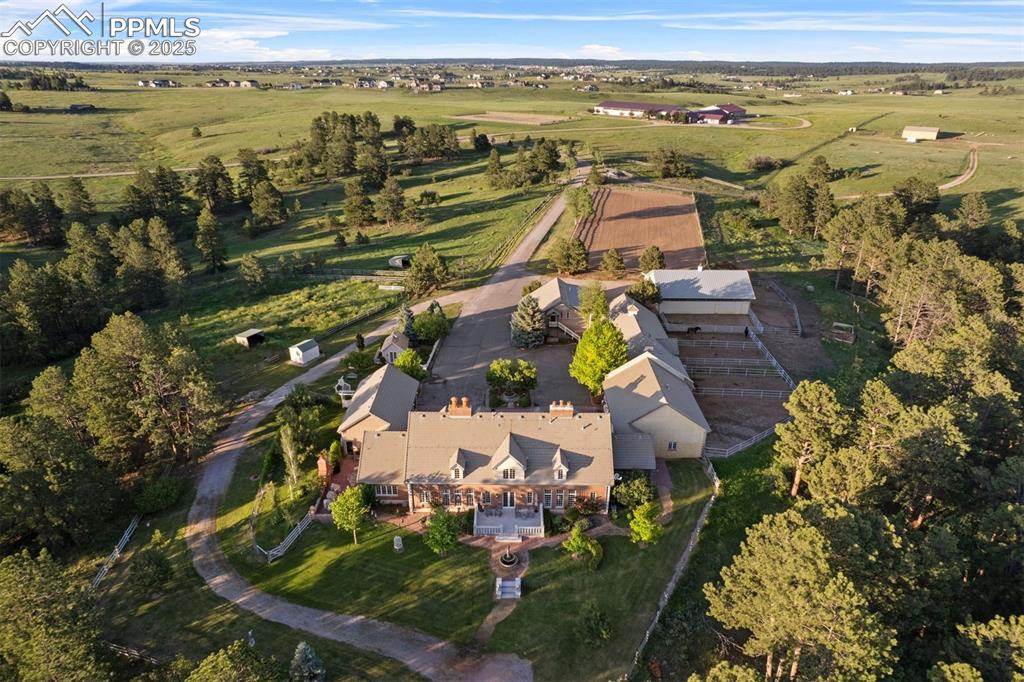 Image 3 of 49: Incredible outdoor living overlooking gardens, a fountain, and rolling mead