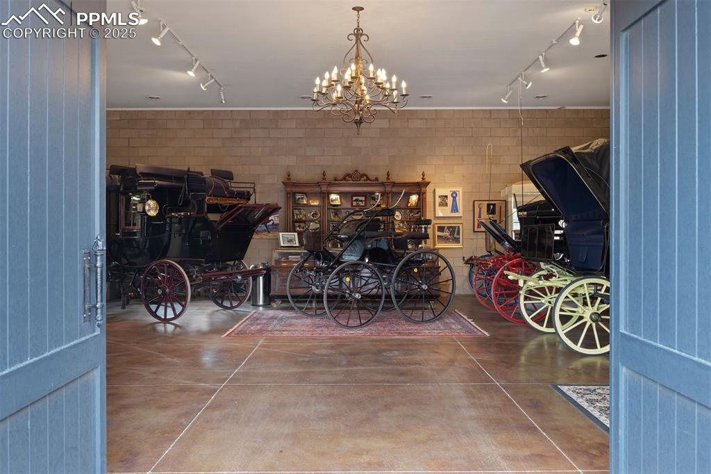 Image 38 of 49: Arched wooden double doors provide a dramatic entry into the carriage house