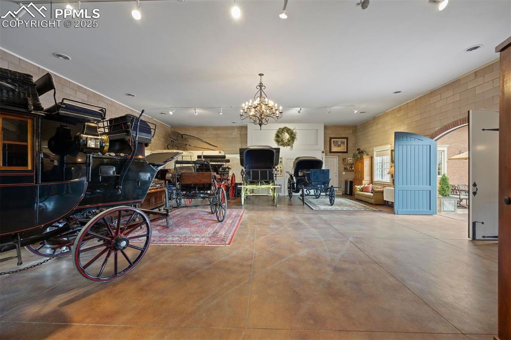 Image 39 of 49: The carriage house features a 14-foot ceiling with a statement chandelier a